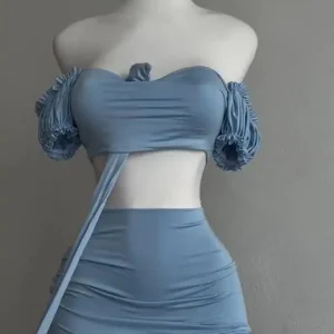 A sexy and fashionable two-piece short skirt with hollowed-out pleated puffed sleeves that wraps the hips